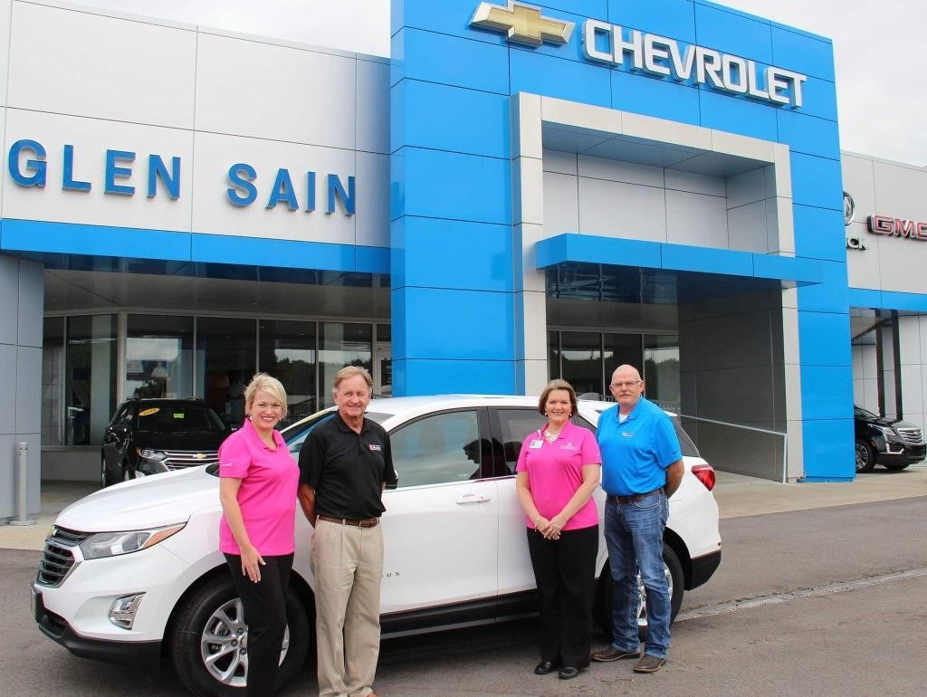 in front of chevrolet office people was standing